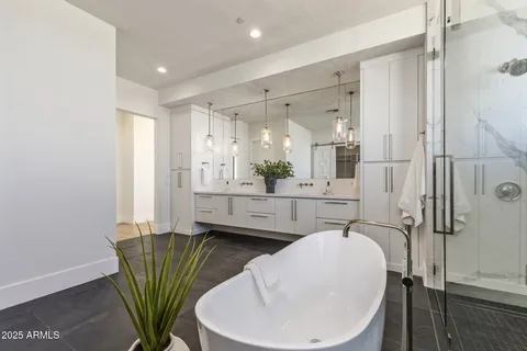 a bathroom with a sink a mirror and a bathtub