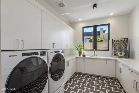 a kitchen with a sink a stove and cabinets