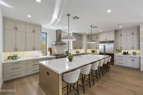 a kitchen with counter space sink stove and chairs