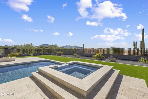 a view of swimming pool with seating area and city view