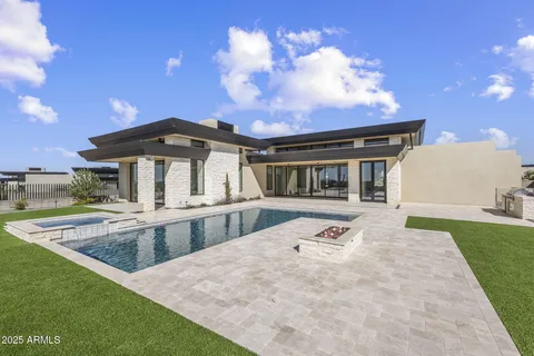 a view of house with yard tub and seating space