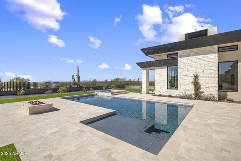 a view of swimming pool with outdoor seating and flat screen tv