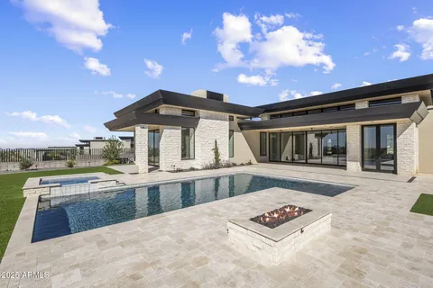 a view of a house with backyard and sitting area