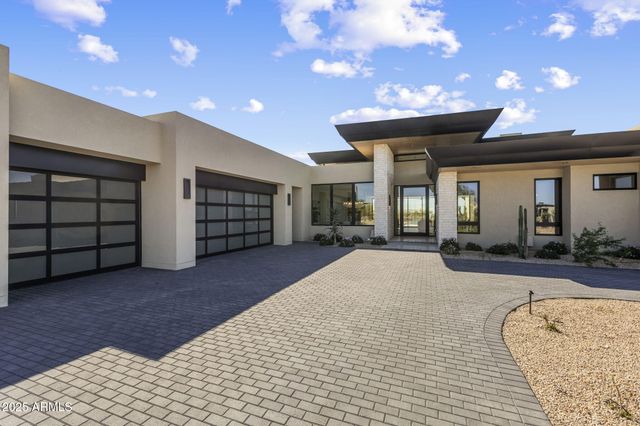 a view of a house with backyard and garage