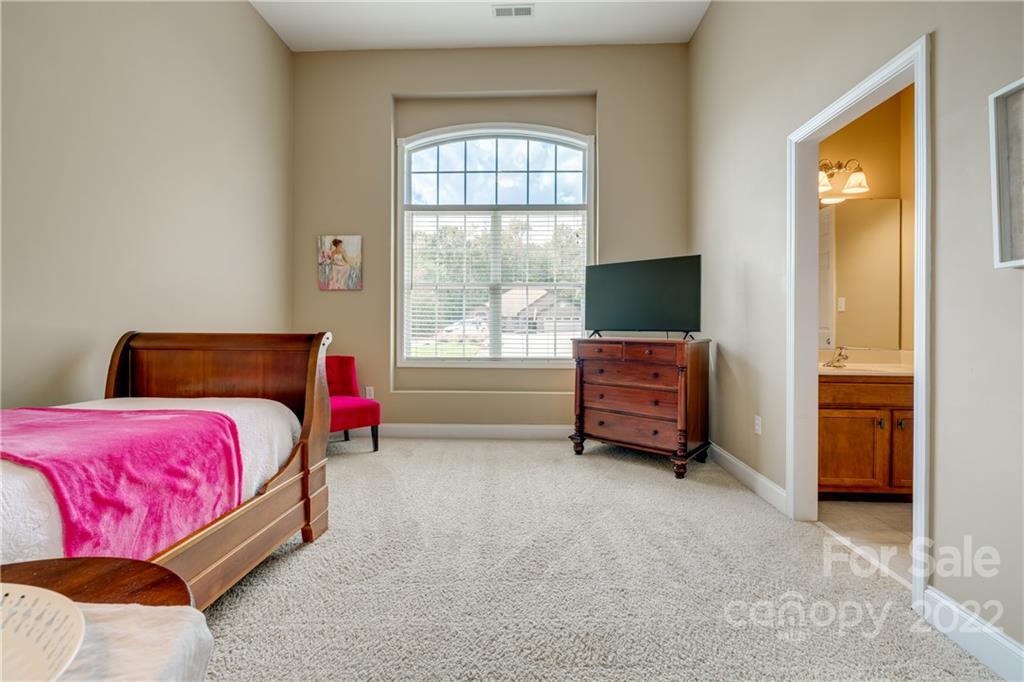 1358 Crown Ridge Drive Fort Mill, SC 29708 - Photo 27 of 47 a bedroom with a bed and large window