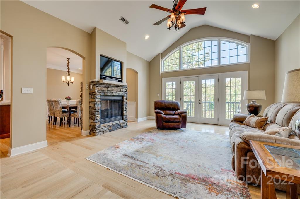 1358 Crown Ridge Drive Fort Mill, SC 29708 - Photo 9 of 47 a living room with furniture a fireplace and a flat screen tv