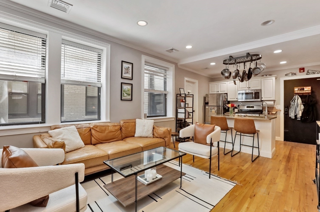 454 Hanover Street, Unit 4 Boston, MA 02113 - Photo 3 of 23 a living room with furniture and a large window