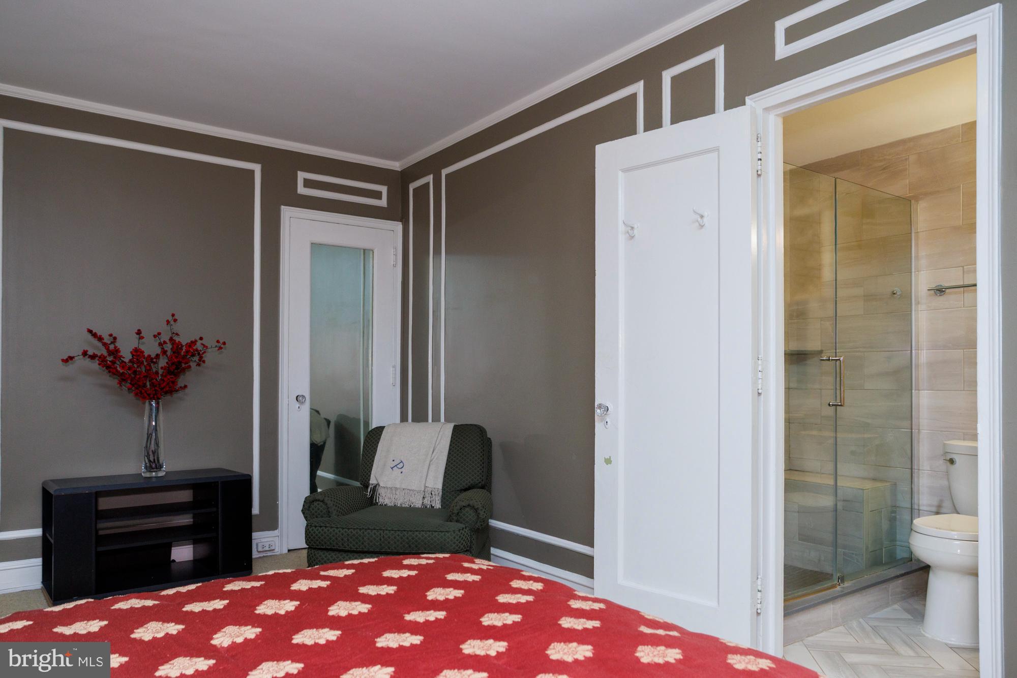 1901 Walnut Street, Unit 2E Philadelphia, PA 19103 - Photo 11 of 21 a bedroom with a bed and a potted plant