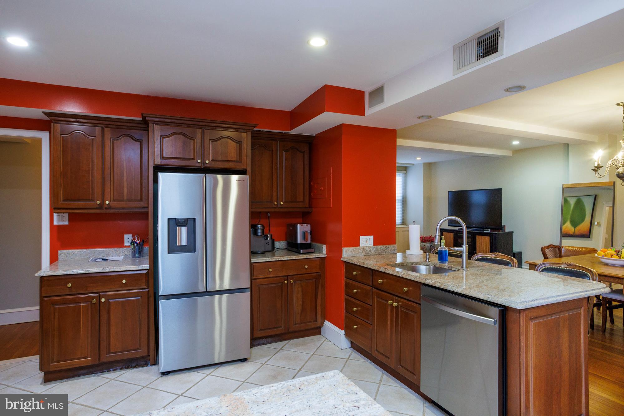 1901 Walnut Street, Unit 2E Philadelphia, PA 19103 - Photo 6 of 21 a kitchen with stainless steel appliances granite countertop a refrigerator a sink and a stove