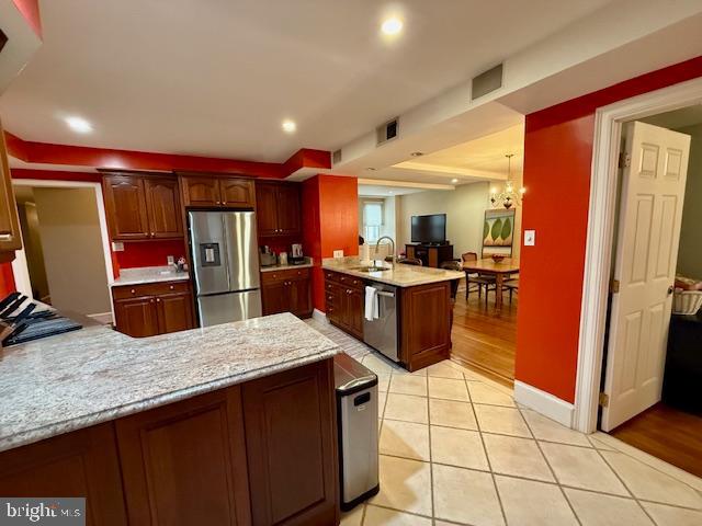 1901 Walnut Street, Unit 2E Philadelphia, PA 19103 - Photo 7 of 21 a kitchen with stainless steel appliances kitchen island granite countertop a refrigerator and a stove