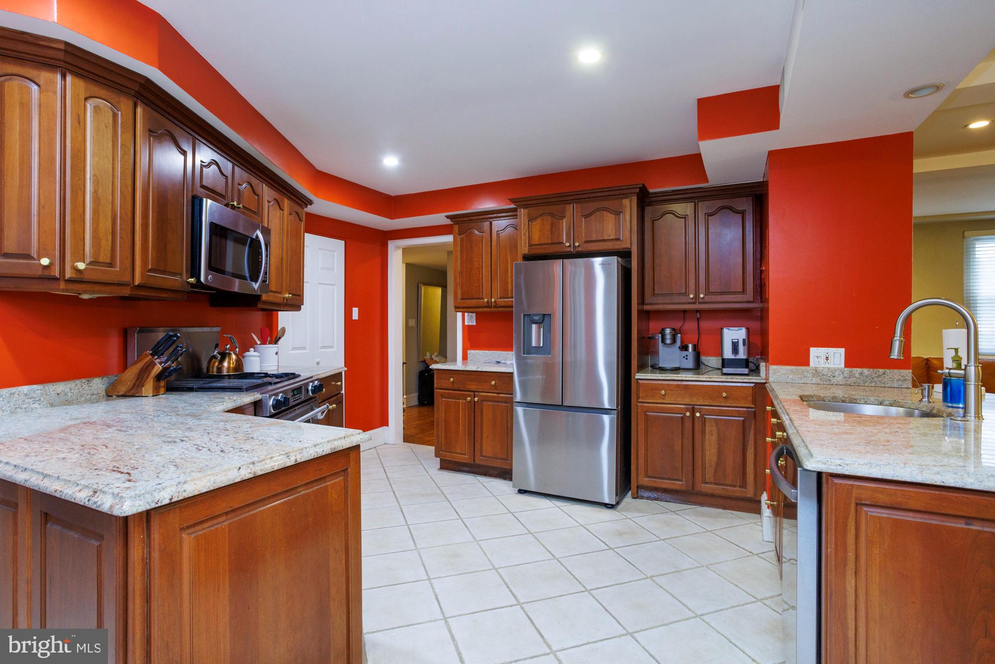 1901 Walnut Street, Unit 2E Philadelphia, PA 19103 - Photo 8 of 21 a kitchen with stainless steel appliances granite countertop a refrigerator and a sink