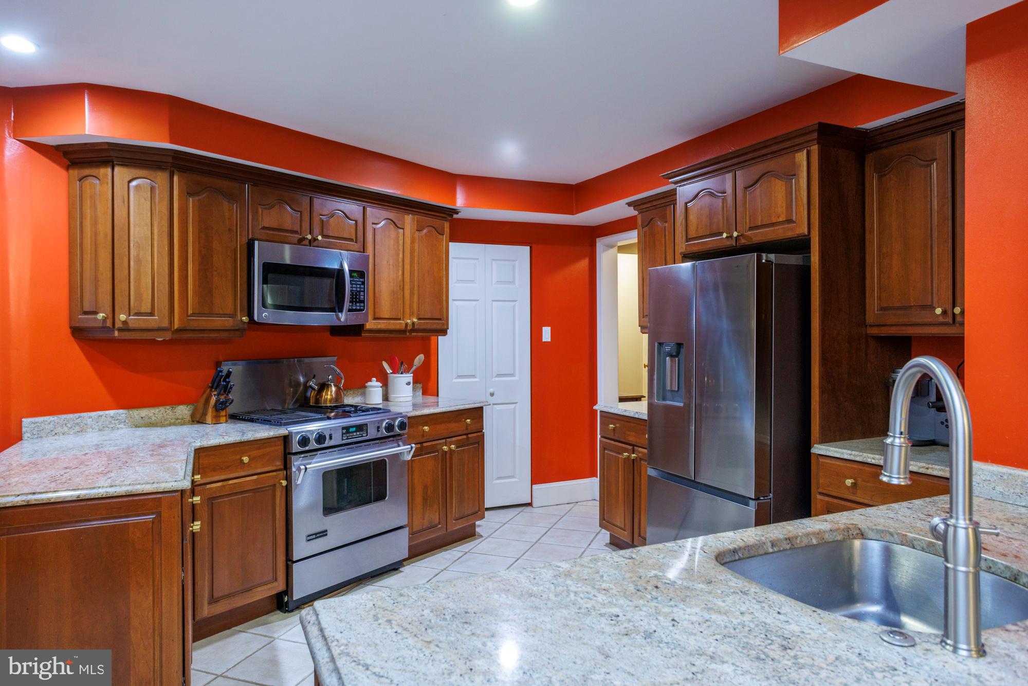 1901 Walnut Street, Unit 2E Philadelphia, PA 19103 - Photo 9 of 21 a kitchen with stainless steel appliances granite countertop a stove top oven a sink and dishwasher