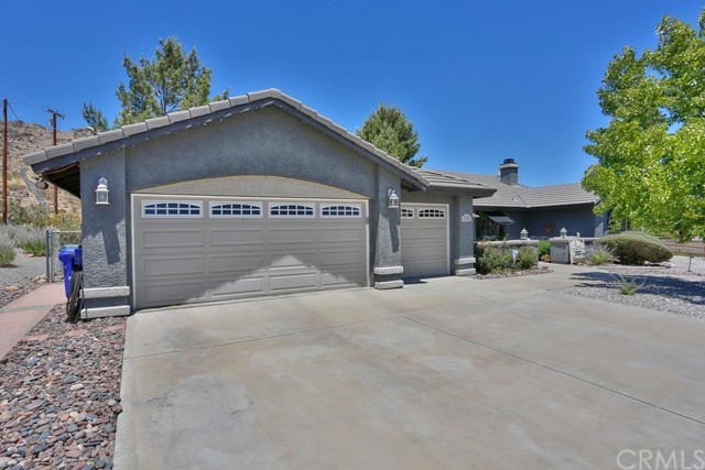 20058 Rancherias Lane Apple Valley, CA 92307 - Photo 11 of 83 a front view of a house with a yard and garage