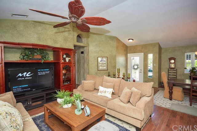 20058 Rancherias Lane Apple Valley, CA 92307 - Photo 22 of 83 a living room with furniture a flat screen tv and a fireplace