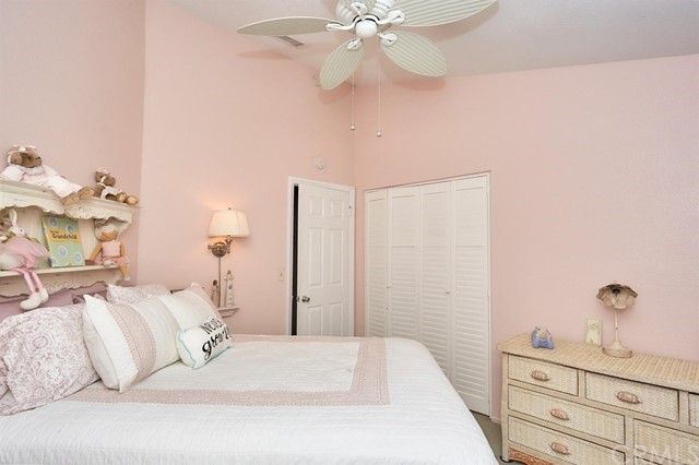 20058 Rancherias Lane Apple Valley, CA 92307 - Photo 39 of 83 a bedroom with a bed and a chandelier