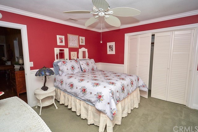 20058 Rancherias Lane Apple Valley, CA 92307 - Photo 44 of 83 a bedroom with a large bed and a chandelier