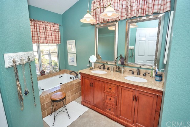20058 Rancherias Lane Apple Valley, CA 92307 - Photo 56 of 83 a spacious bathroom with double vanity sink a two mirror a window a bathtub and vanity