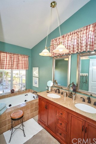 20058 Rancherias Lane Apple Valley, CA 92307 - Photo 57 of 83 a bathroom with a sink and a large mirror