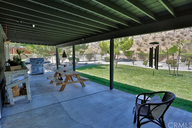 20058 Rancherias Lane Apple Valley, CA 92307 - Photo 61 of 83 a view of yard with a table and chairs under an umbrella