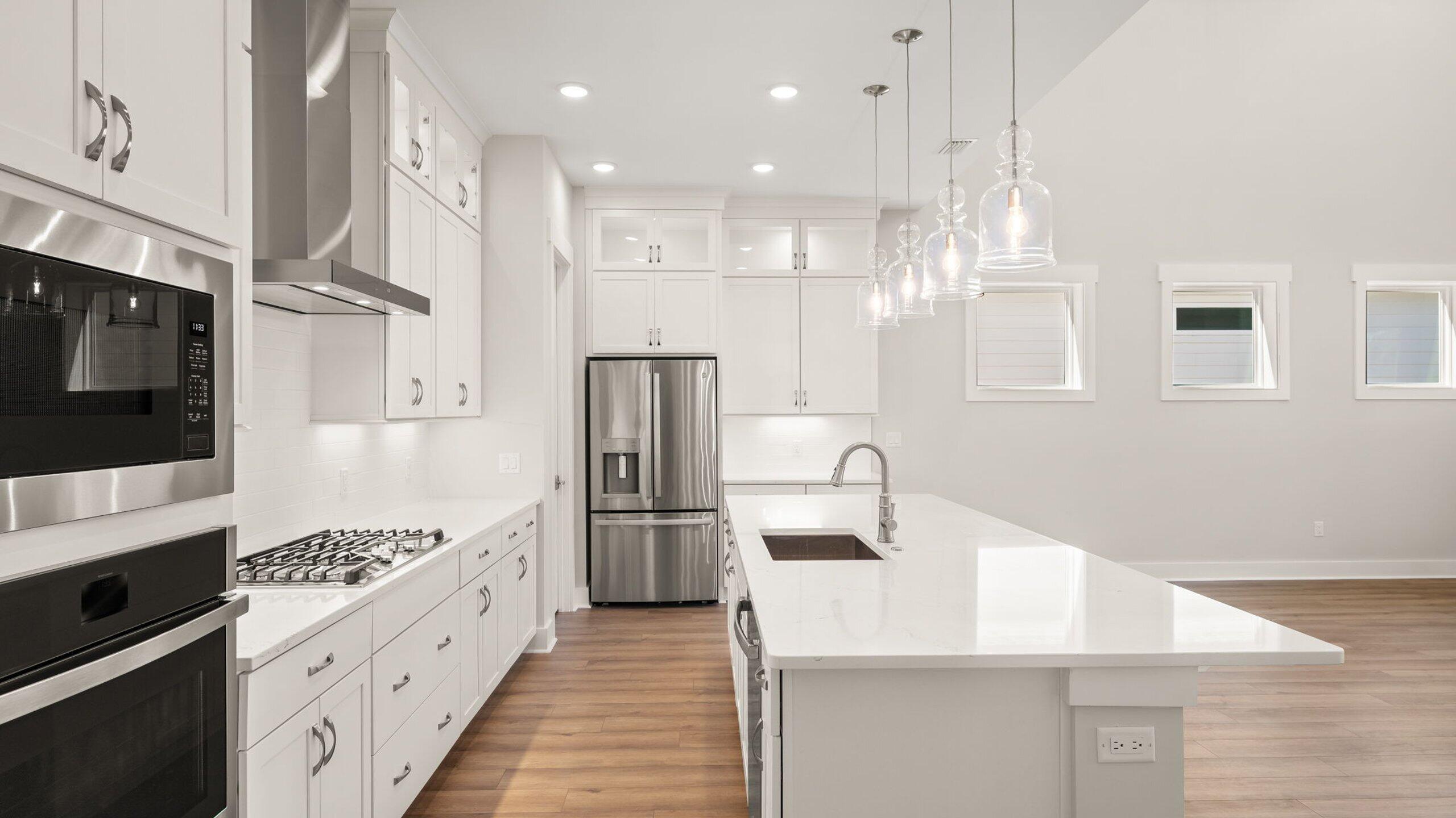 40 Dunns Circle Inlet Beach, FL 32461 - Photo 3 of 69 a kitchen with stainless steel appliances kitchen island granite countertop a refrigerator a sink and white cabinets