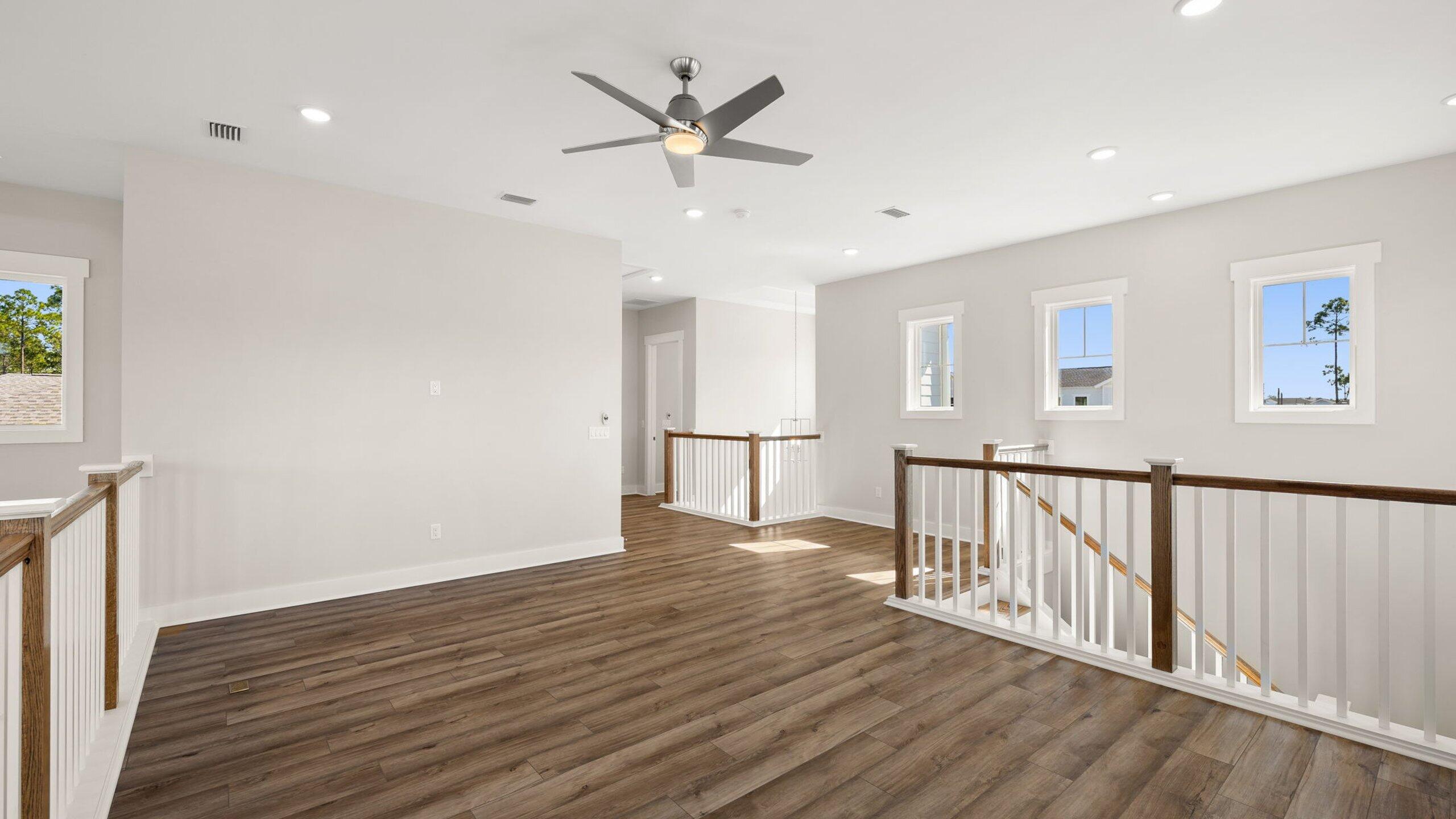 40 Dunns Circle Inlet Beach, FL 32461 - Photo 35 of 69 a view of an empty room with wooden floor and a ceiling fan