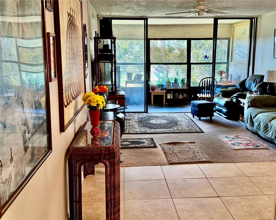 12300 Vonn Road, Unit 5304 Largo, FL 33774 - Photo 3 of 21 a living room with furniture and floor to ceiling windows