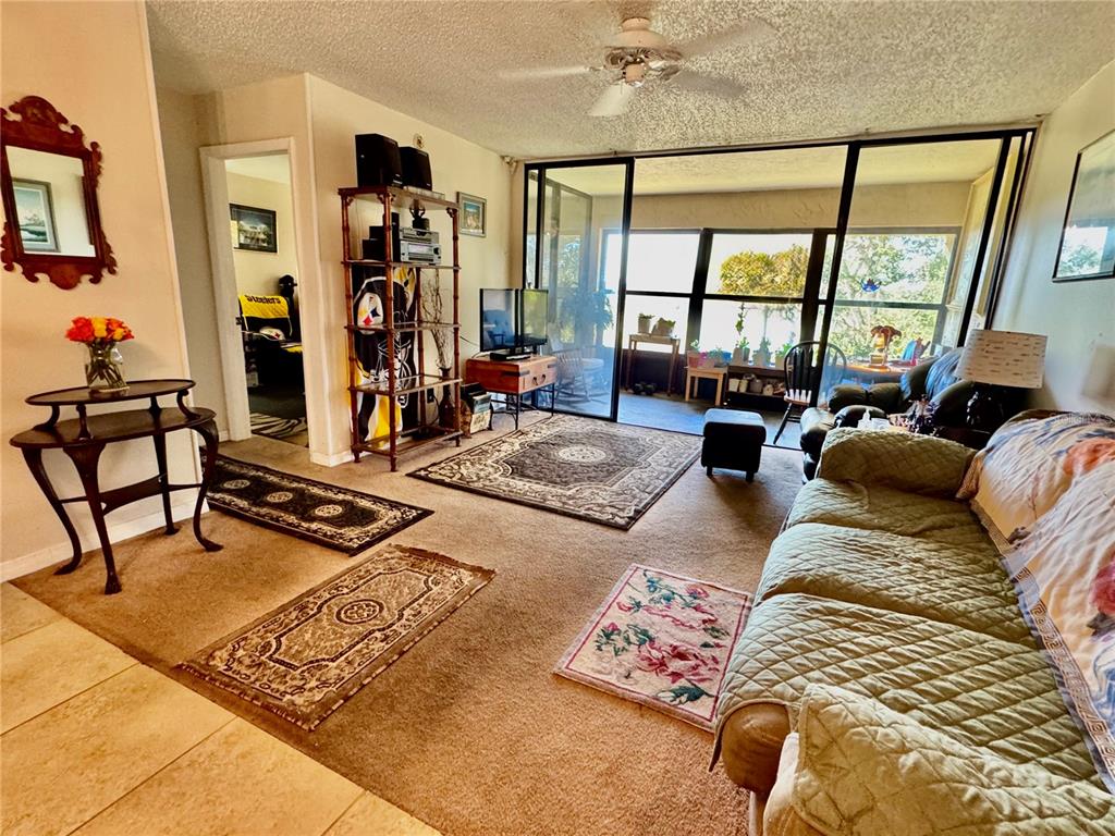 12300 Vonn Road, Unit 5304 Largo, FL 33774 - Photo 5 of 21 a living room with furniture and a floor to ceiling window