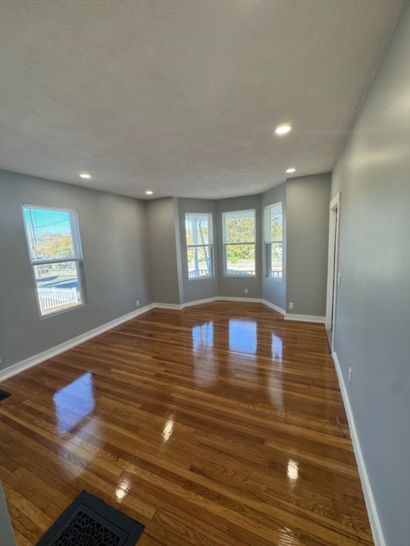 193 Winter Street, Unit 1 Saugus, MA 01906 - Photo 6 of 15 a room with wooden floor and window