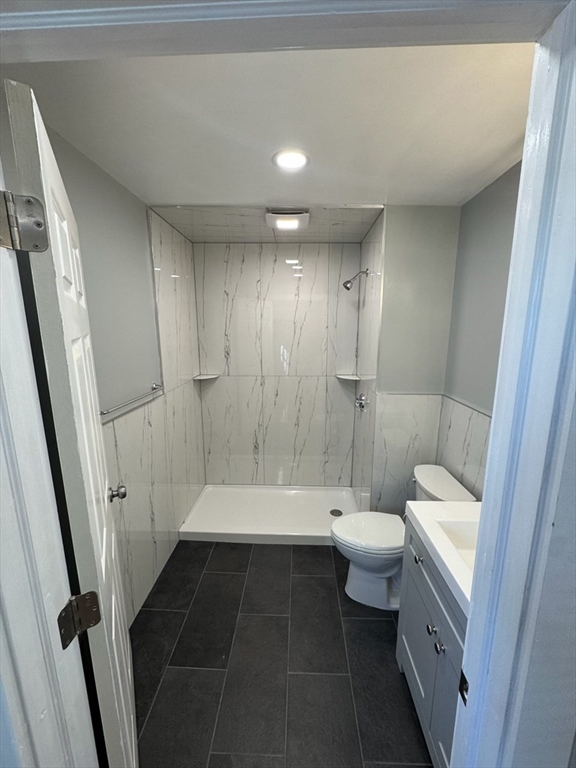 193 Winter Street, Unit 1 Saugus, MA 01906 - Photo 10 of 15 a bathroom with a double vanity sink toilet and shower