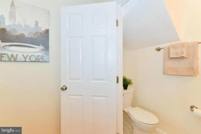 a white toilet sitting next to a shower