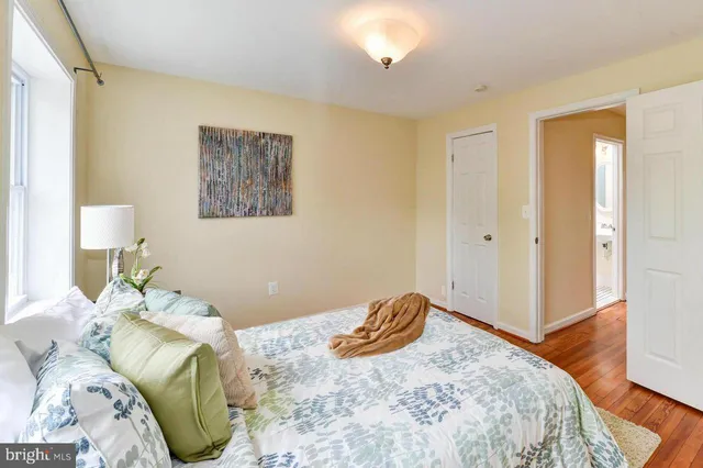 a bedroom with a bed and a mirror