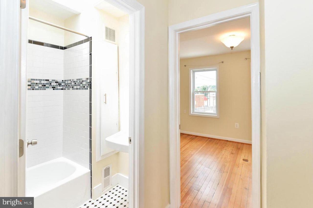 1648 L Street Northeast Washington, DC 20002 - Photo 17 of 27 a bathroom with a glass shower door