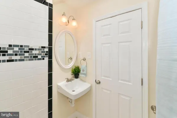 a bathroom with a sink a mirror and shower