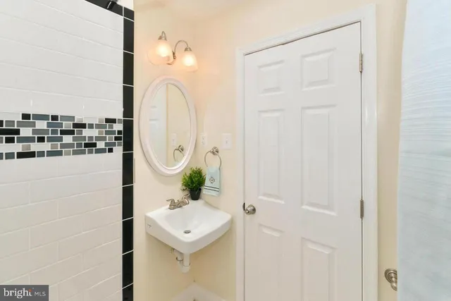 a bathroom with a sink a mirror and shower