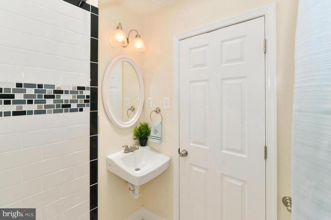 1648 L Street Northeast Washington, DC 20002 - Photo 18 of 27 a bathroom with a sink a mirror and shower