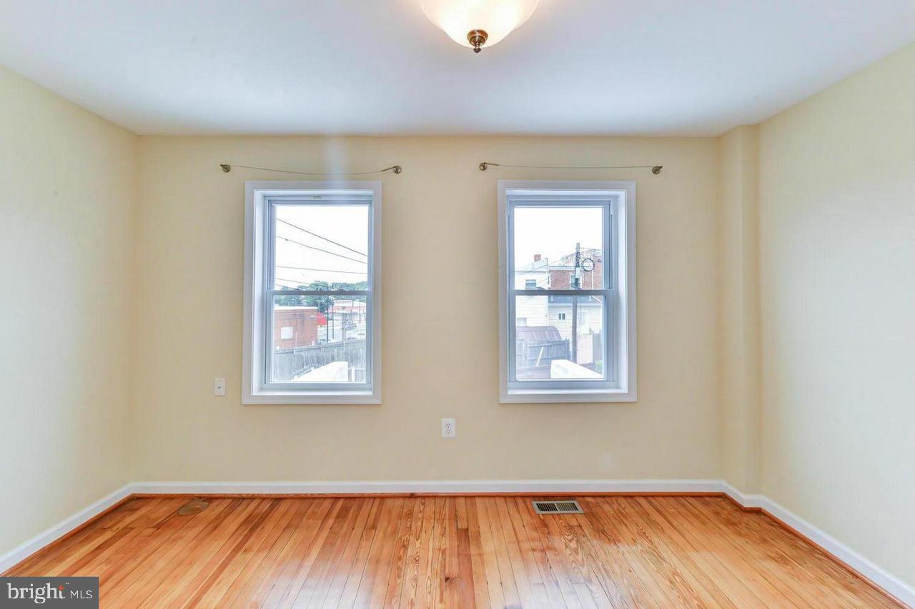 1648 L Street Northeast Washington, DC 20002 - Photo 20 of 27 an empty room with wooden floor and windows