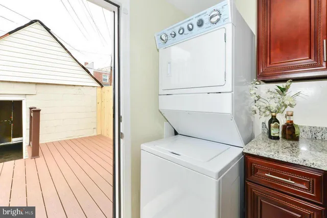 a view of washer and dryer with wooden floor