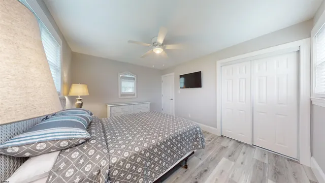 a bedroom with a large bed and a chandelier