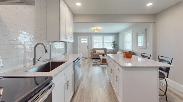 a kitchen with a sink a counter top space and appliances