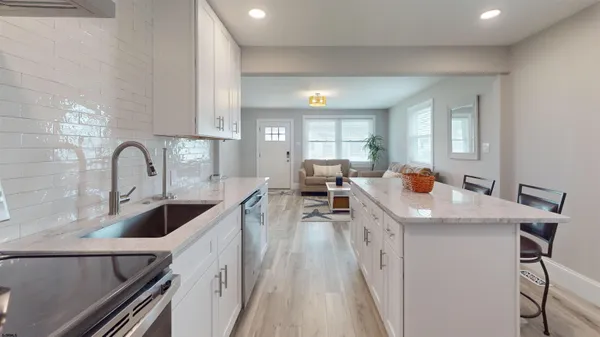 a kitchen with a sink a counter top space and appliances