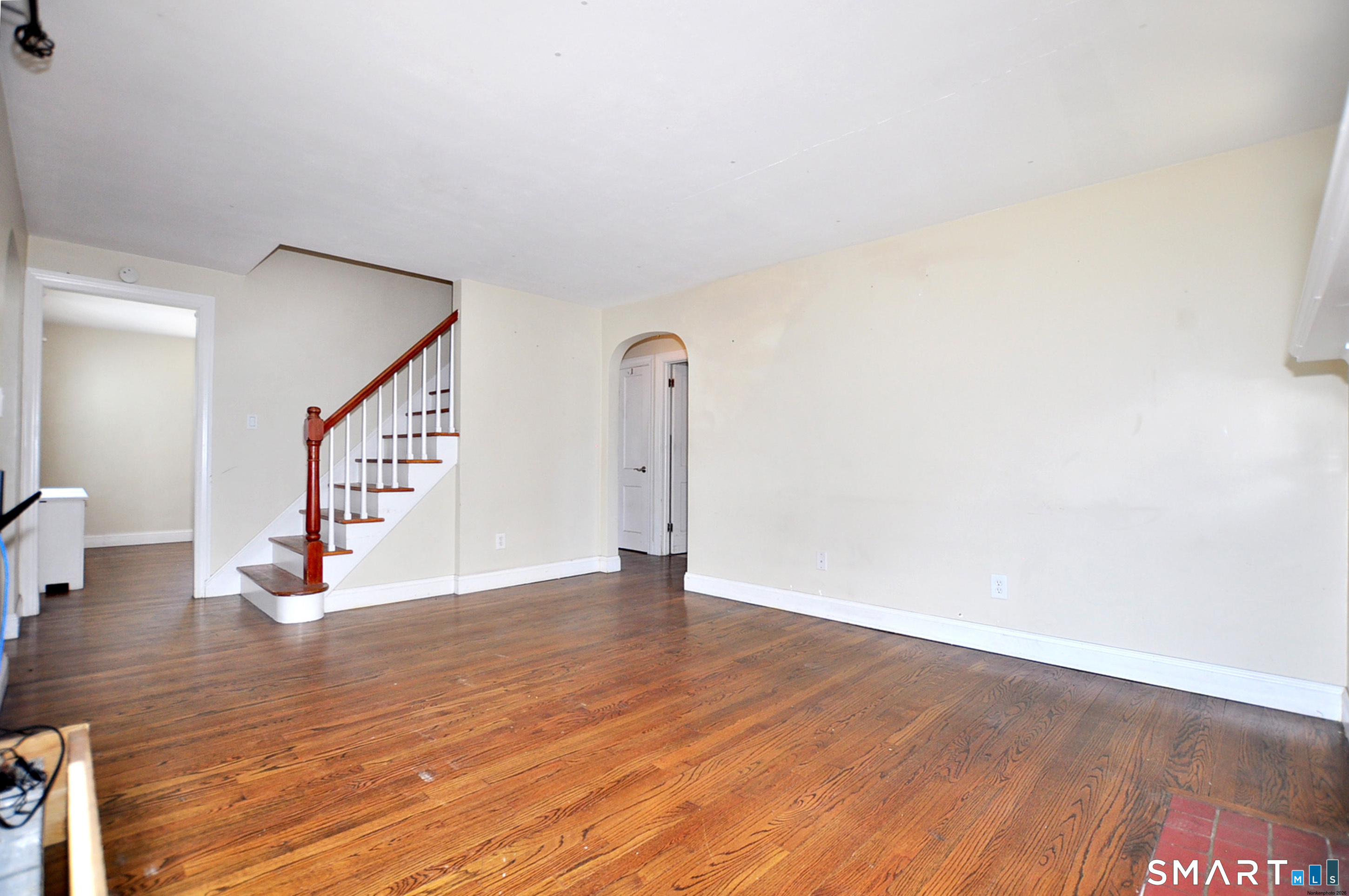 103 West Center Street Manchester, CT 06040 - Photo 9 of 29 a view of an empty room with wooden floor and stairs