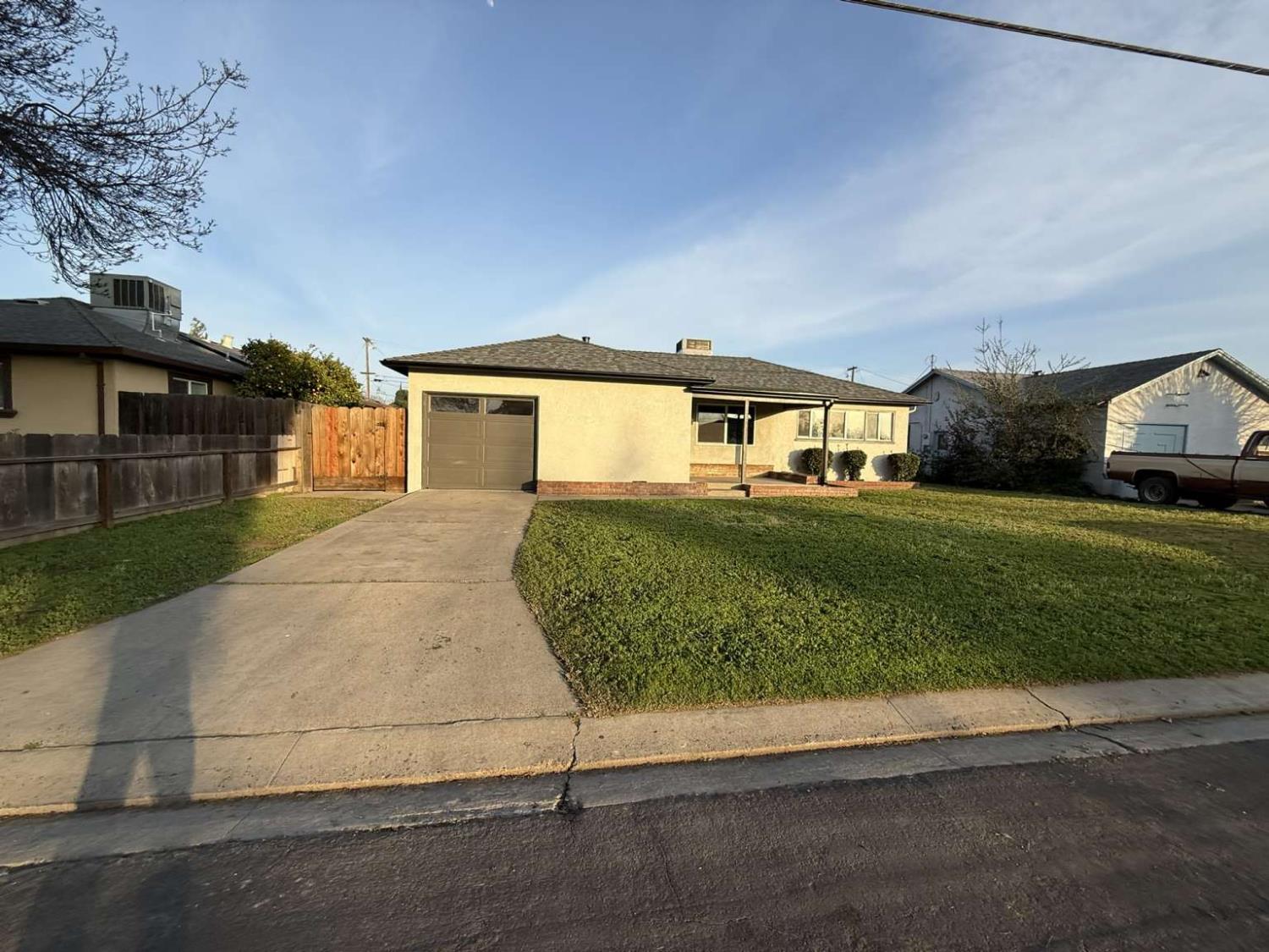 520 Colfax Avenue Modesto, CA 95354 - Photo 13 of 18 a front view of a house with a yard and garage