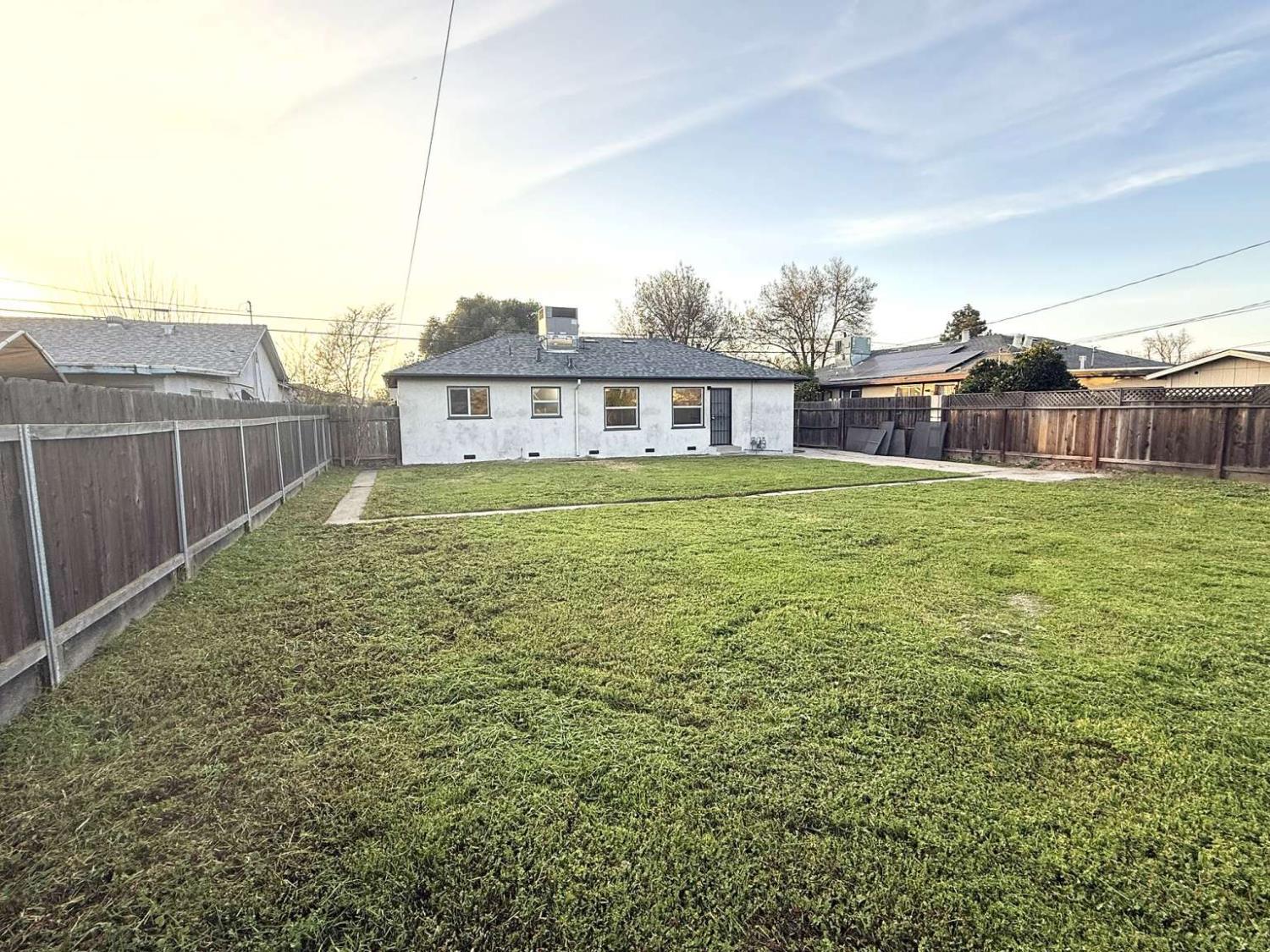 520 Colfax Avenue Modesto, CA 95354 - Photo 15 of 18 a view of a house with a yard and a fence