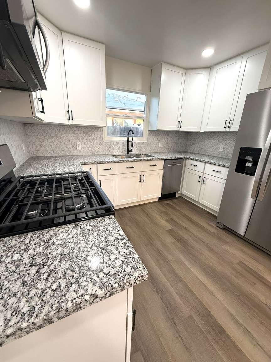 520 Colfax Avenue Modesto, CA 95354 - Photo 7 of 18 a kitchen with a stove a sink and a microwave