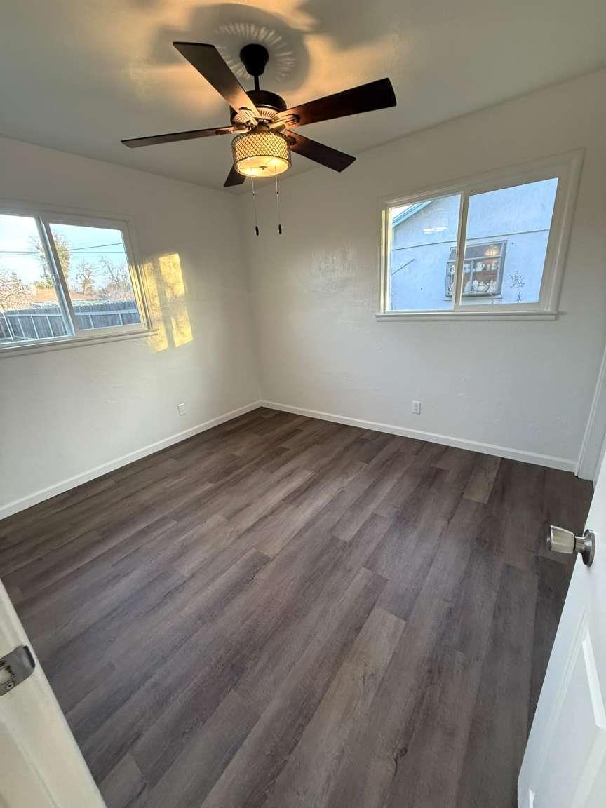 520 Colfax Avenue Modesto, CA 95354 - Photo 8 of 18 wooden floor in an empty room with a window