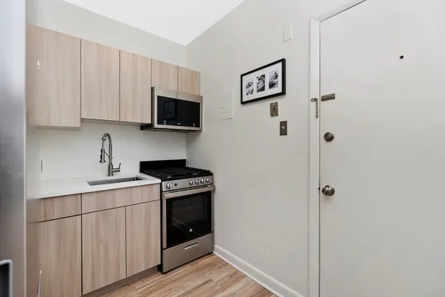 a kitchen with stainless steel appliances a refrigerator stove and sink