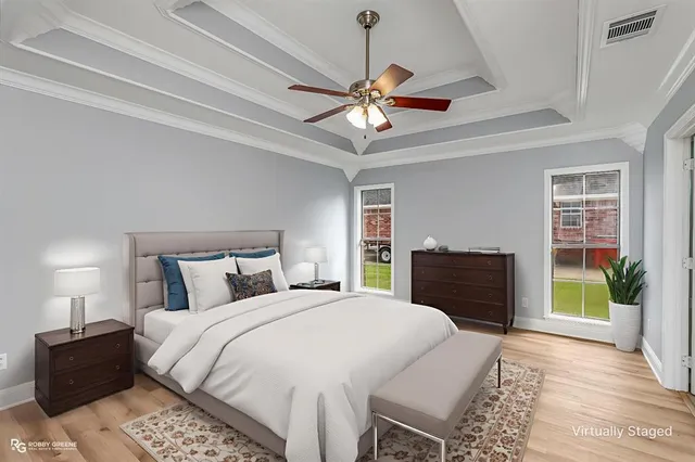 a bedroom with a bed and a chandelier