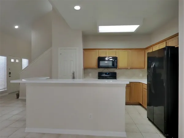 a kitchen with stainless steel appliances a refrigerator and a stove