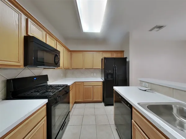 a kitchen with a sink stove and microwave