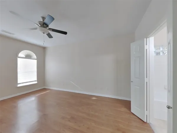 an empty room with windows and closet